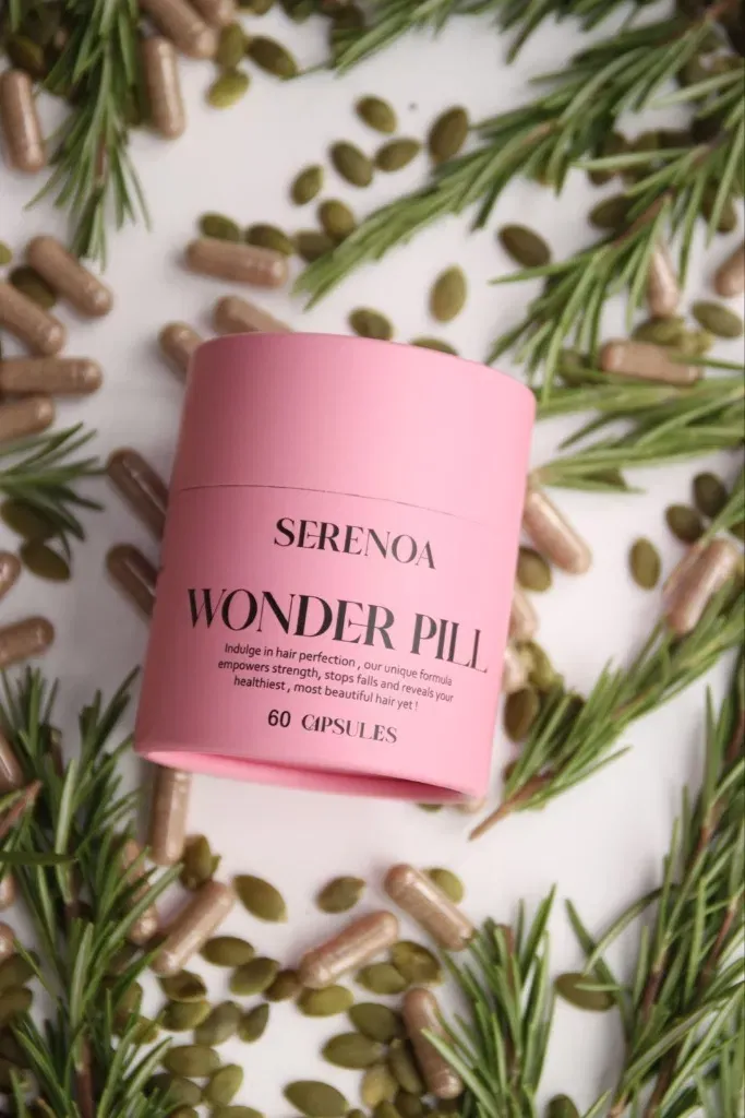 Serenoa Wonder Pill pink supplement jar with rosemary, capsules and pumpkin seeds